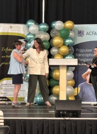 Mme Mireille Péloquin, directrice générale de l'Association des parents francophones de l'Alberta,  a gauche, recevant les hommages de ses collaboratrices à la fin du sommet : « On ne transmet pas seulement une langue, on transmet des humains. »
 &mdash; Crédit : Le Franco