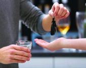 Close up view of drunk man giving car key to woman, on blurred background. Don't drink and drive concept  