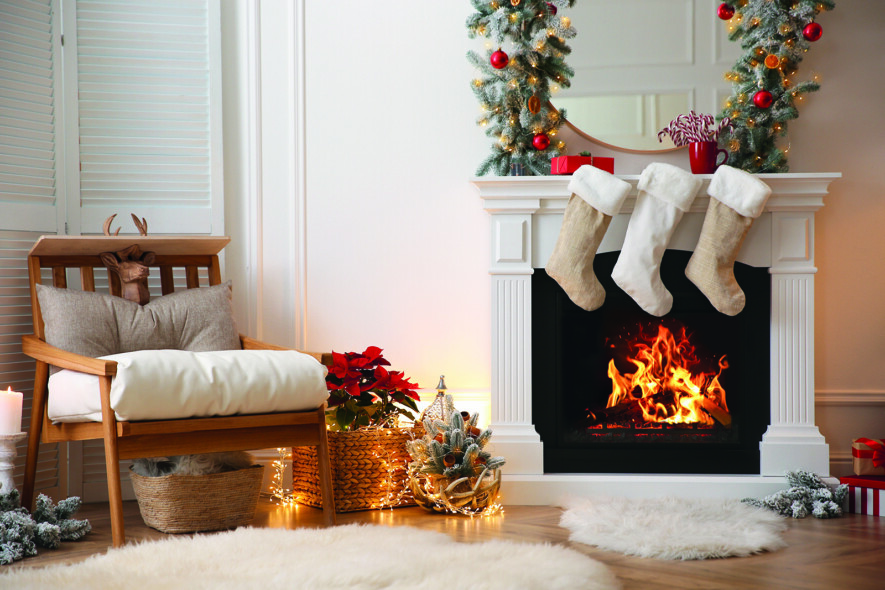 Fireplace with Christmas stockings in beautifully decorated living room  