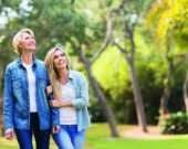 happy mother and daughter in the forest bird watching  