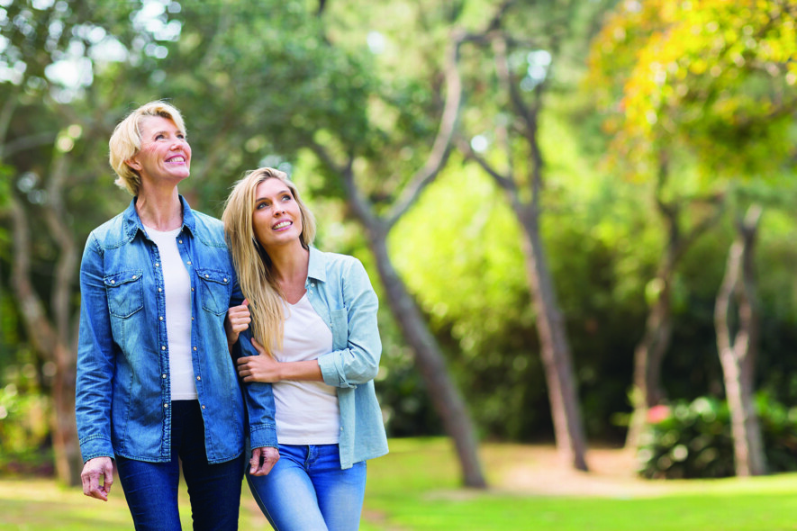 happy mother and daughter in the forest bird watching  