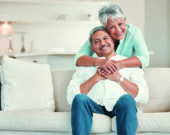 a happy senior couple relaxing on the sofa at home.  