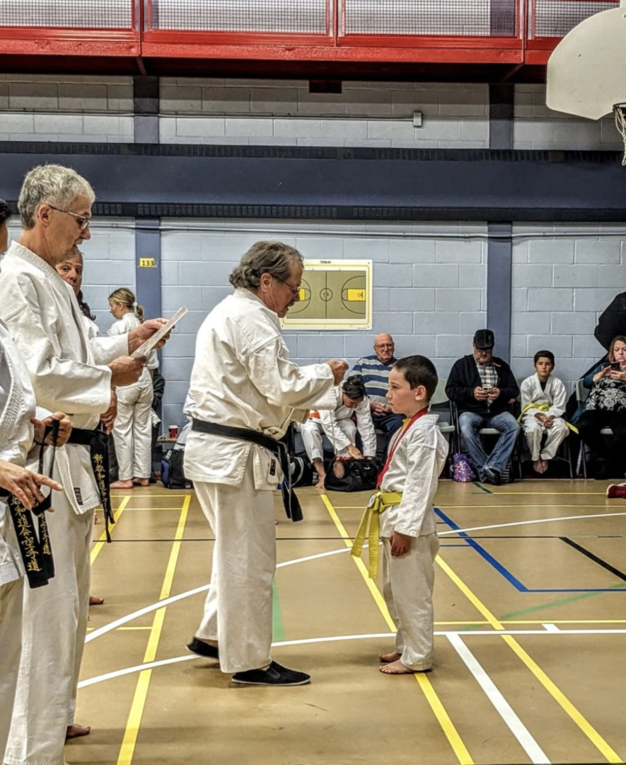 André Rhéaume remettant une médaille  &mdash; Photo : Karaté Hearst/Facebook