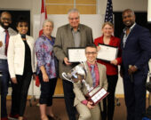 De gauche à droit : Rangée arrière - Leslie Benfield, directeur croissance des clubs D123; Iona Rodricks, directrice de la qualité des programmes D123; Kris Nelson, directrice de district D123; Mario Keriakedes, 2e place, Deborah Walker, 3e place, Roger Caesar, président du concours D123. Rangée avant – (celui avec le gros trophée) Alexandre Matte, 1re place. &mdash; Photo : Courtoisie