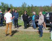 Au « 1er cimetière des Quatorze Vieux » de Chéticamp, Scott Aucoin explique le chemin à suivre pendant la promenade pendant que le professeur Clint Bruce enregistre ses propos.   &mdash; Karmen d’Entremont