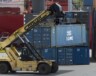 Un chariot élévateur déplace un conteneur dans un terminal de fret, à Saint-Jean, le dimanche 25 juin 2023. LA PRESSE CANADIENNE/Adrian Wyld &mdash; Adrian Wyld